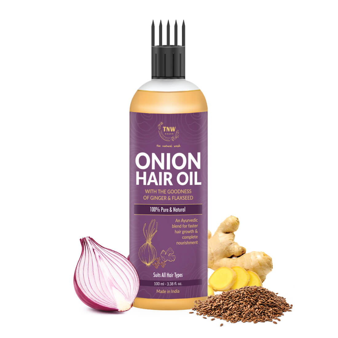 Bottle of onion hair oil with ingredients on a white background